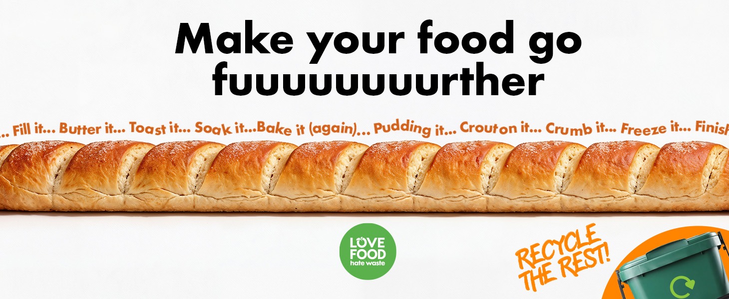 A wide banner showing a long loaf of sliced bread stretching across the image. Above the bread, bold text reads “Make your food go fuuuuuurther,” with smaller text listing ideas such as filling, buttering, toasting, soaking, baking again, pudding, croutons, crumbs, freezing, and finishing leftovers. The Love Food Hate Waste logo appears below, alongside the message “Recycle the rest!” and an illustration of a food waste caddy.